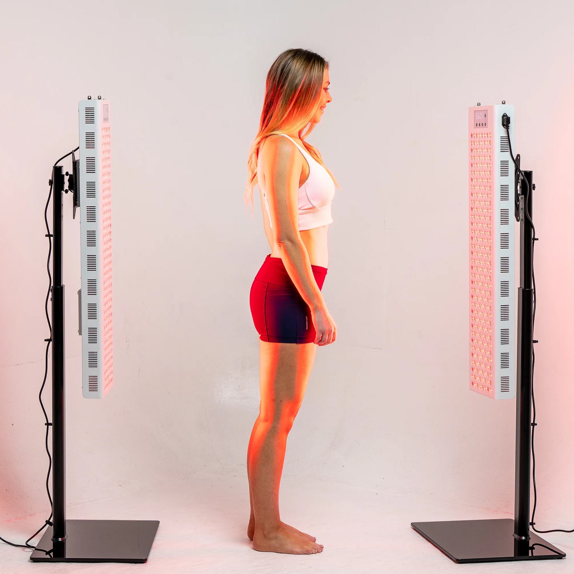 Person standing between two illuminated RedRush 840 PULSE panels