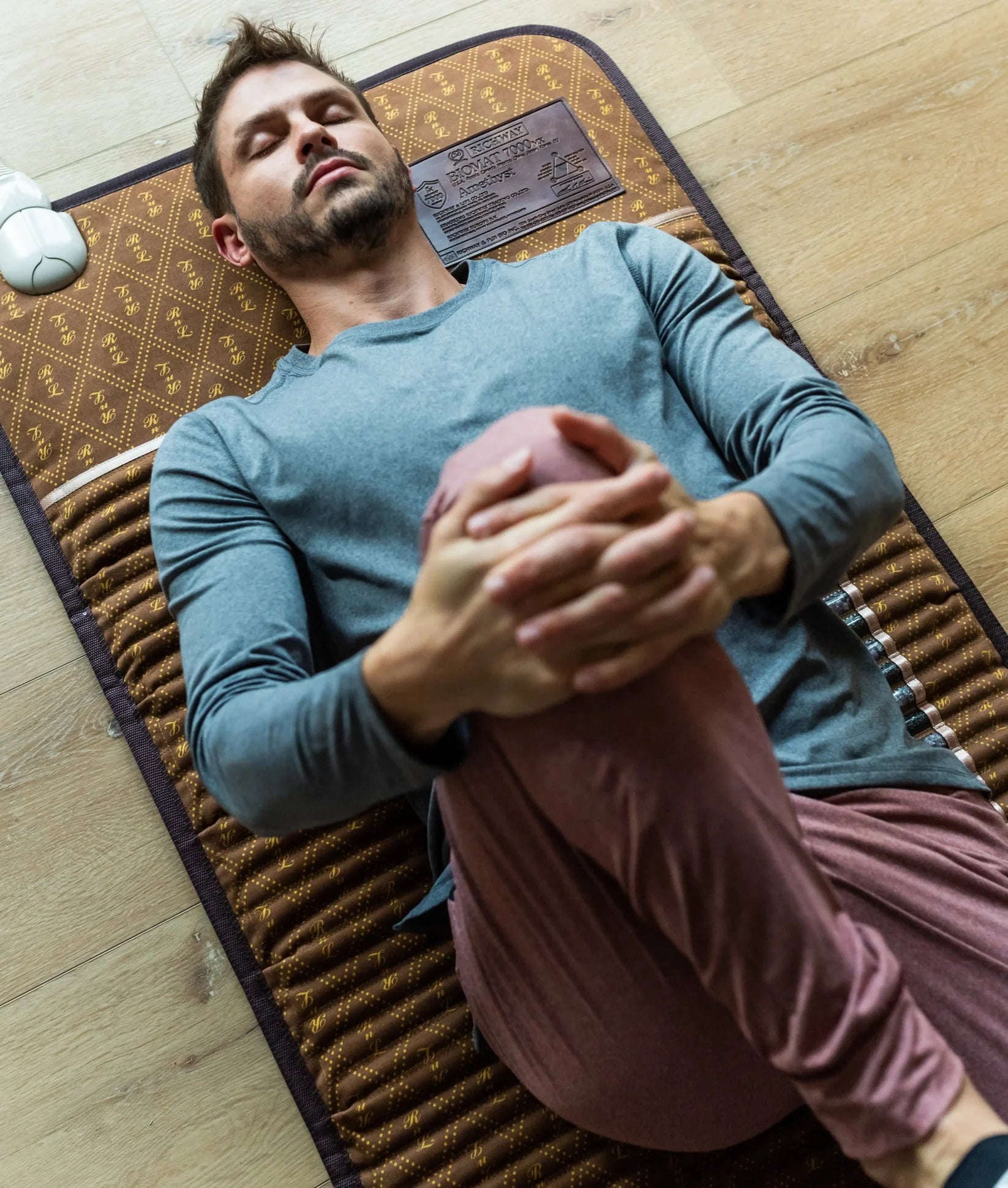 Person stretching on the BioMat Professional full-body infrared therapy mat